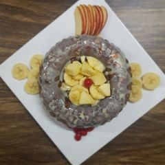 A picture of Apple Cake twisted garnishing with milkmaid and honey.