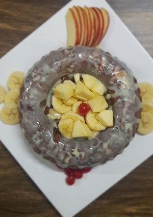 A picture of Apple Cake twisted garnishing with milkmaid and honey.