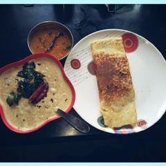 A picture of Masala Dosa with coconut chutney & sambhar.