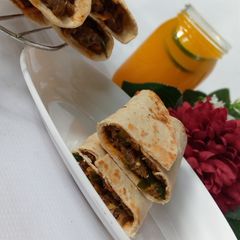 A picture of Saucy beef wraps.