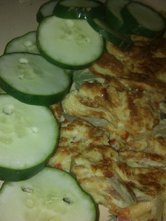 A picture of Fried egg garnish with cucumber.