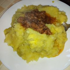 A picture of Mashed bananas with beef stew.