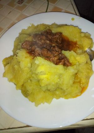 A picture of Mashed bananas with beef stew.