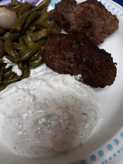 A picture of Ground Beef Croquettes with White Sauce.