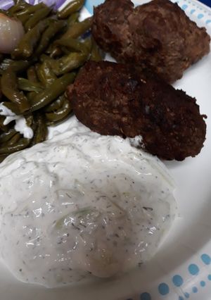 A picture of Ground Beef Croquettes with White Sauce.