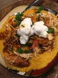 Shredded barbecue chicken over grits