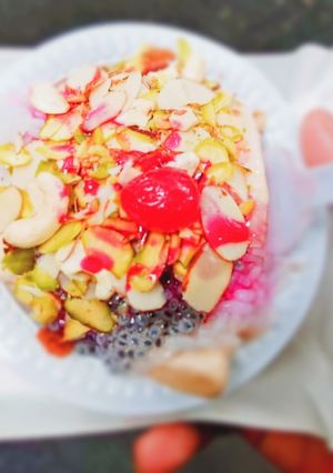A picture of Kulfi falooda with dry fruit and rose syrup.