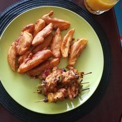 A picture of Chicken mshikaki and potatoes.