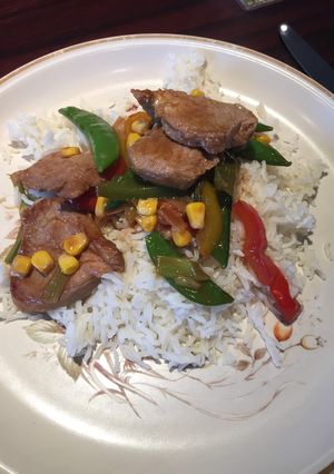 A picture of Stir fried Pork with spring onions and sugar snaps.