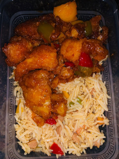 A picture of Stir fried basmati rice and sweet and sour fish fillet.