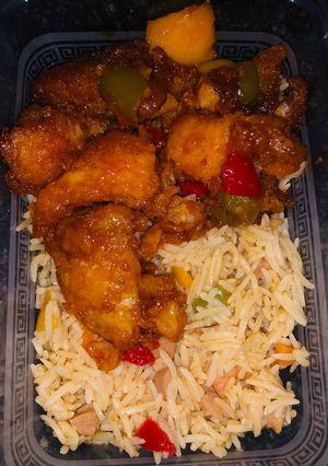 A picture of Stir fried basmati rice and sweet and sour fish fillet.