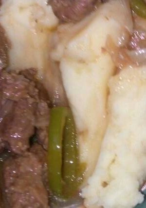 A picture of Cream of mashed potato served with beef stew.