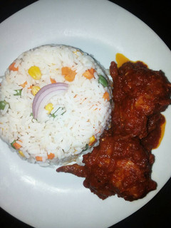 A picture of Boiled rice with tomato sauce.