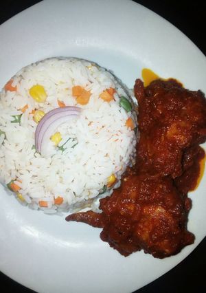 A picture of Boiled rice with tomato sauce.