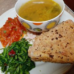 Alou roti water cress saag tomato chutney and dal A picture of Alou roti water cress saag tomato chutney and dal.
