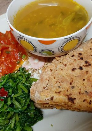 A picture of Alou roti water cress saag tomato chutney and dal.
