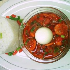 A picture of Boiled rice with simple tomato stew.