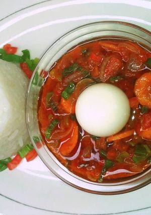 A picture of Boiled rice with simple tomato stew.