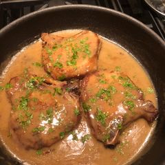 A picture of Bone-in Center Cut Pork Chops w/gravy.