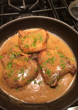 A picture of Bone-in Center Cut Pork Chops w/gravy.