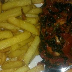 A picture of Chips and tomatoes sauce with shrimps and veggiei.