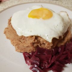 A picture of Corned Beef Hash with a fried egg on top.