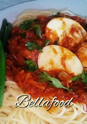 A picture of Spaghetti with egg curry and french beans.