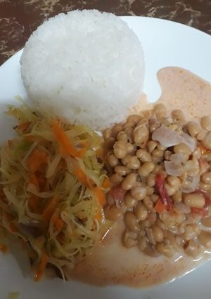 A picture of Rice, steamed cabbage and coconut beans.