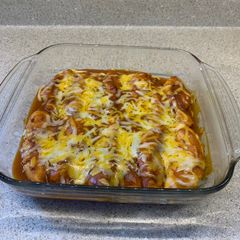 A picture of Chicken fillets bakedIn enchilada sauce.