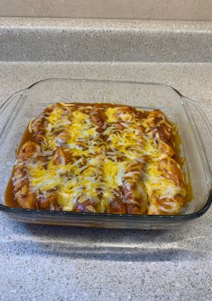 A picture of Chicken fillets bakedIn enchilada sauce.