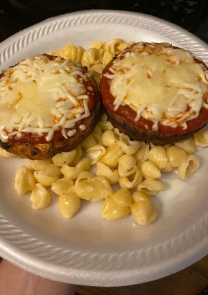A picture of Veggie parmesan over mac & cheese.