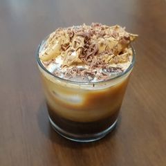 A picture of İce Coffee with coffee cream on top.