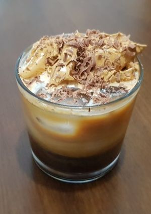 A picture of İce Coffee with coffee cream on top.