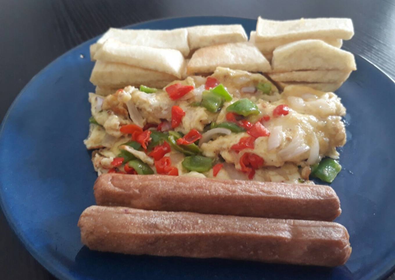 Fried yam with fried egg and sausages