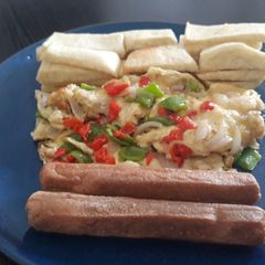 A picture of Fried yam with fried egg and sausages.
