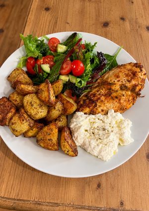A picture of Crispy Greek chicken with lemon potatoes & whipped feta salad.