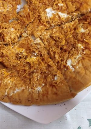 A picture of Tandoori chicken pizza on stove.