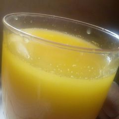 A picture of Turmeric and ginger juice with clove and honey.