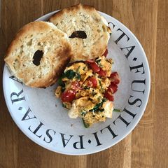 A picture of Simple scrambled eggs with tomato and spinach.
