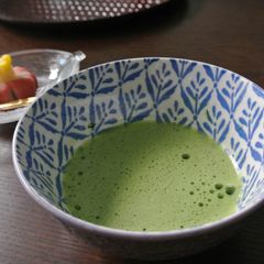 A picture of Preparing a cup of Matcha on a table.