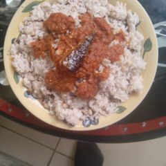 A picture of Rice and beans with stew.