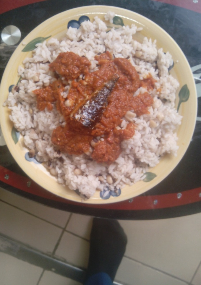 A picture of Rice and beans with stew.