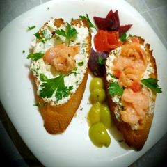 A picture of Grilled toast with feta cheese flavored with herbs and salmon.