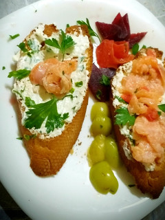 A picture of Grilled toast with feta cheese flavored with herbs and salmon.