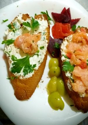 A picture of Grilled toast with feta cheese flavored with herbs and salmon.