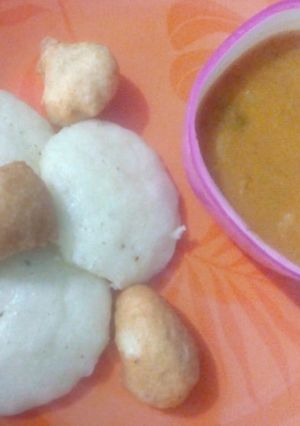 A picture of Sambhar with vada and idli.
