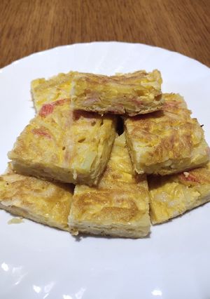A picture of Fried Egg with Potato and Crab Stick.