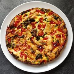 A picture of Kale, tomato & goat cheese quiche.
