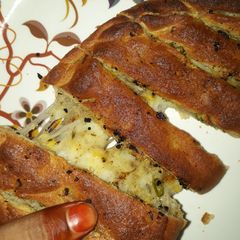 A picture of Stuffed wheat flour Cheezy Garlic Bread .