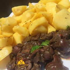 A picture of Potatoes and kidney sauce.
